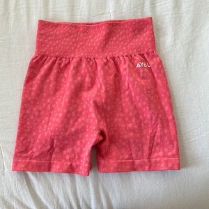bright pink AYBL workout shorts